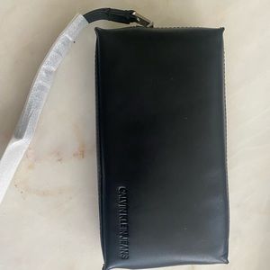 NWT and original casing - Calvin Klein Jeans black wristlet